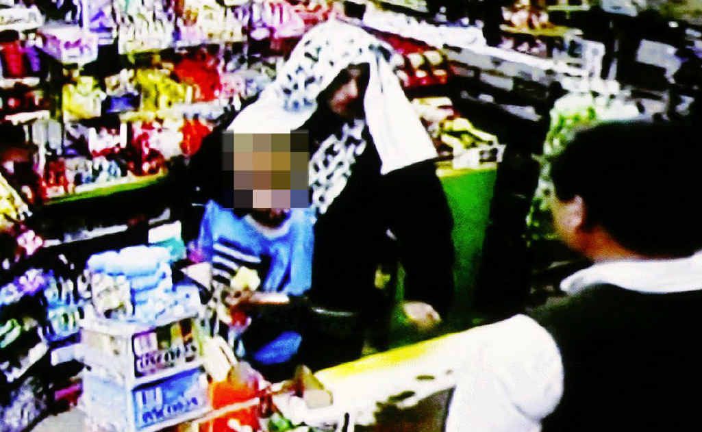 LOW ACT: Desmond Samuel Johns holds a broken bottle to a 12-year-old boy’s throat. Photo: Contributed LOW ACT: Desmond Samuel Johns holds a broken bottle to a 12-year-old boy’s throat. Photo: Contributed